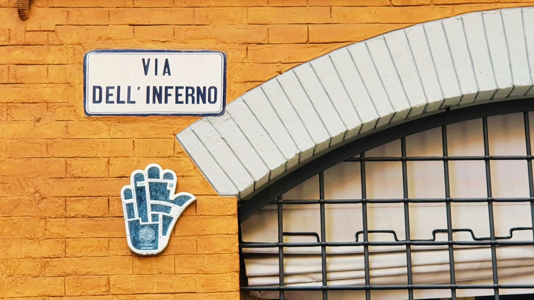 a yellow brick wall with a sign and a hand painted on it