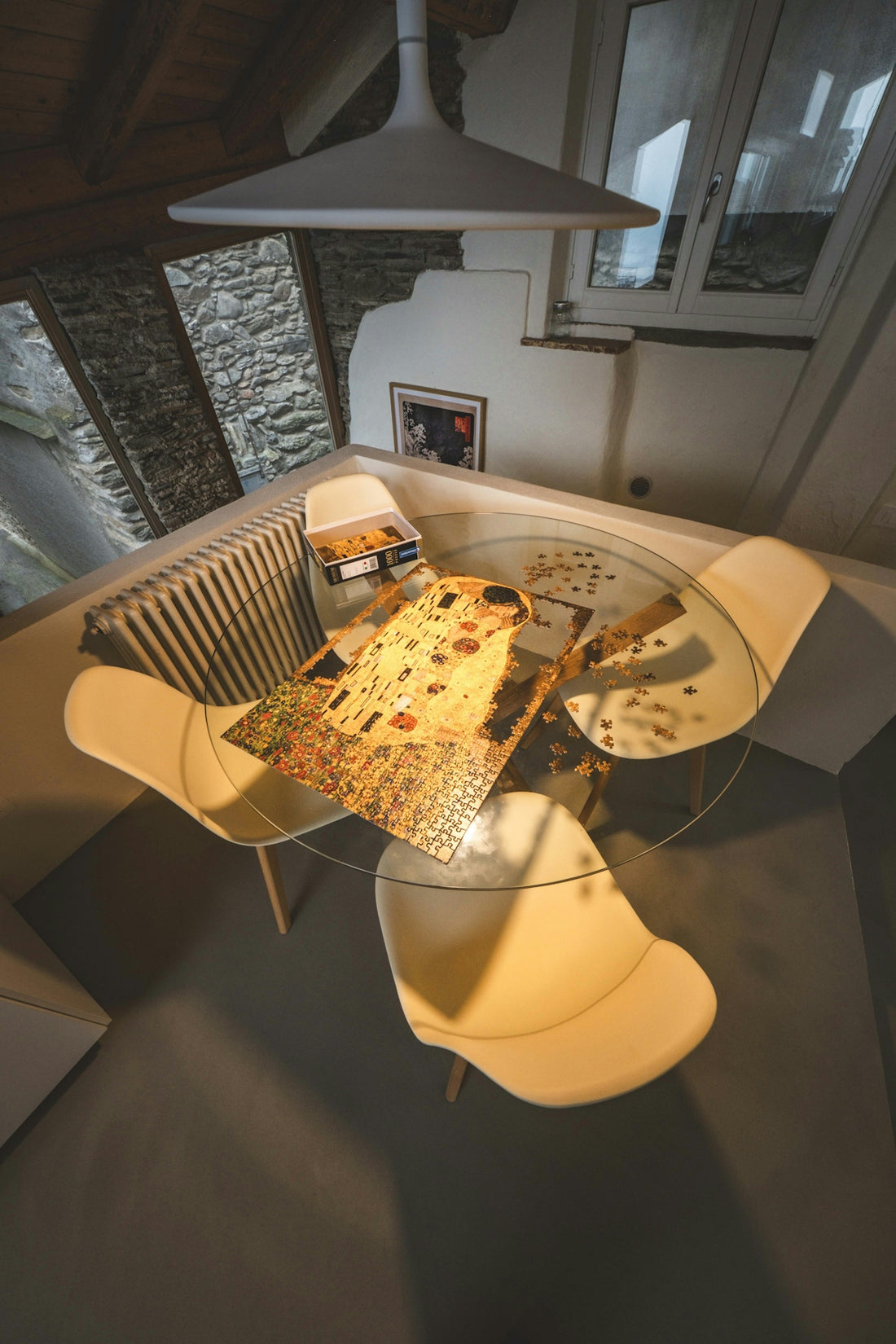 A room with a glass table and a lamp