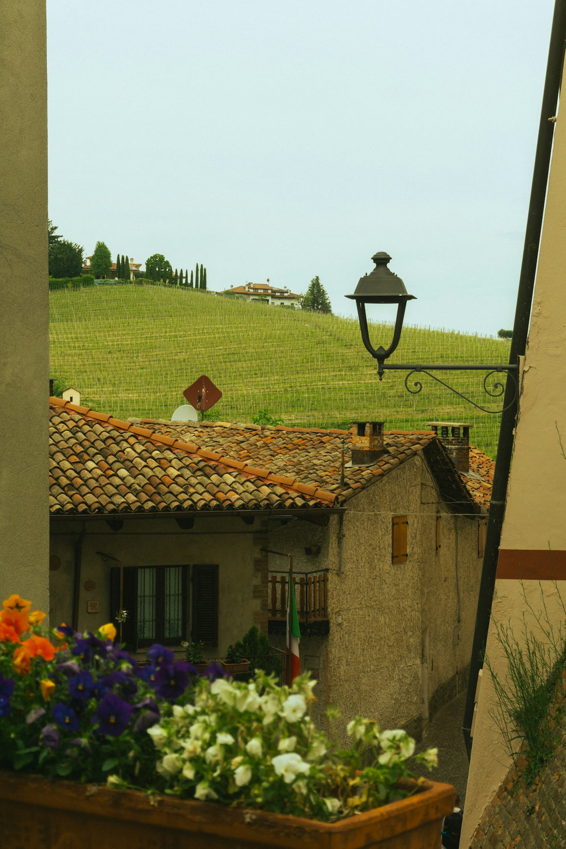 View of a building and rolling green hills.