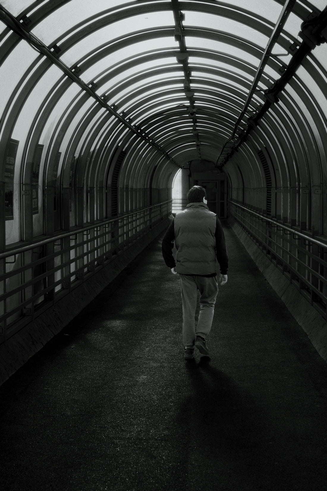 Man walking through a modern covered walkway
